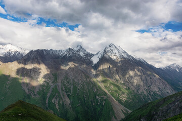 Mountain landscape view in Kyrgyzstan. Green grass in mountain valley view. Mountain panorama.