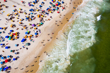 Aerial view of sandy beach with beach umbrellas and sun loungers. South Beach, Miami.