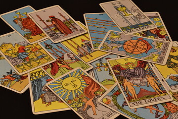 Tarot cards spread out on black background