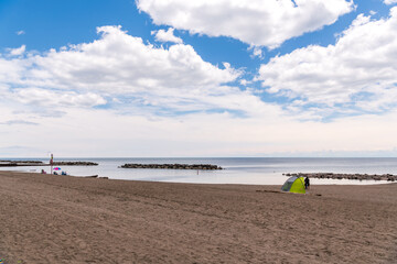 Fototapeta na wymiar Beach at midday in June with few users and big sky. Shot in the Toronto Beaches