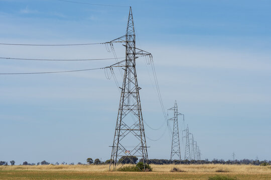 A row of electricity stanchions receding into the distance