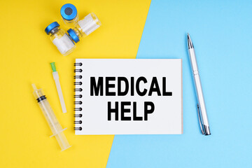 A syringe, ampoules and a notebook with the inscription - MEDICAL HELP