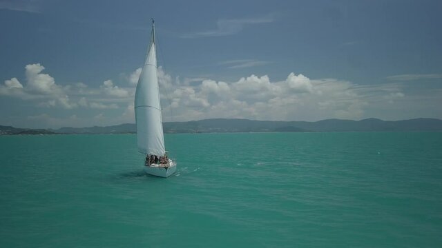Yacht scene of sailboat - taken with drone - koh samui in Thailand -drone circeling the sailboat &ndash; with all sails up