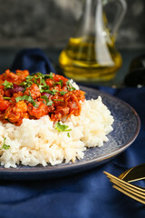 Plate with tasty chili con carne and rice on table, closeup