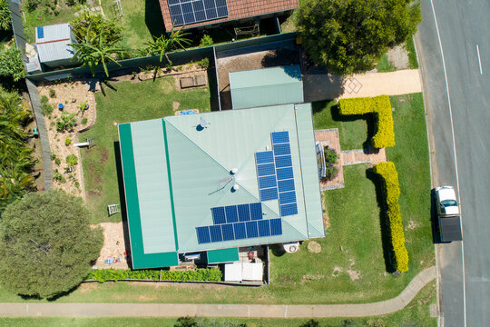 Looking down on house with metal roof and solar panels.