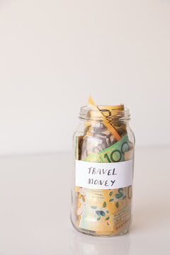 Copy space and jar of australian notes with travel money written on it