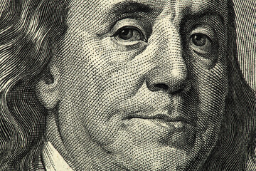 Macro close up of Ben Franklin's face on the US $100 dollar bill. 