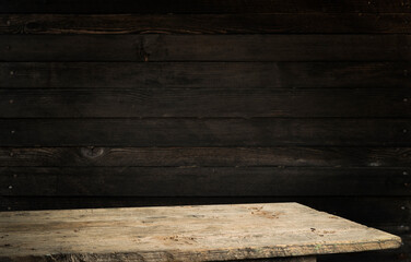 Old wood table with smoke in the dark background.