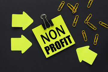 non profit. text on a black background, on a bright yellow sticker, near bright yellow stickers and...