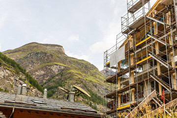 New construction of high-rise buildings construction site in the center of the city against the backdrop of a mountain ridge