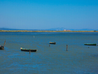 Boats on a small part of the Mediterranean sea protected from the waves by a tongue of land towards Port-Saint- Louis-du-Rh&ocirc;ne in Provence in France