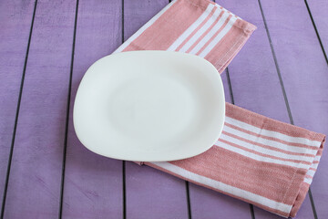 White clean empty plate, cotton napkin on colored background. Concept of breakfast, lunch, dinner. Top and side views.