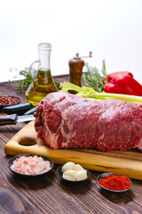 Raw beef fillet with vegetables on kitchen table