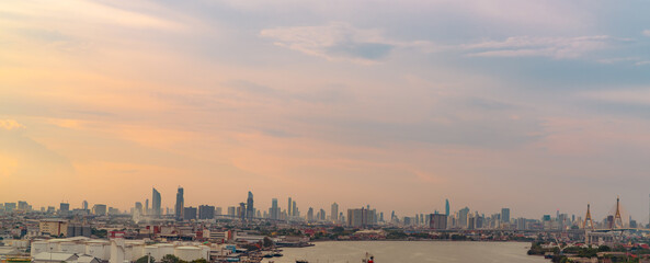 Cityscape of modern building. Cityscape in Asia. Business office building. City with sunset sky. Horizontal view of city with crowd of skyscraper building and the river. Capital city in Thailand.