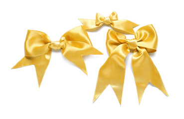 Beautiful golden bows on white background