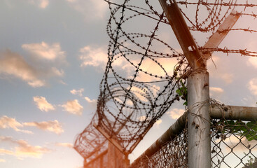 Prison security fence. Barbed wire security fence. Razor wire jail fence. Barrier border. Boundary...