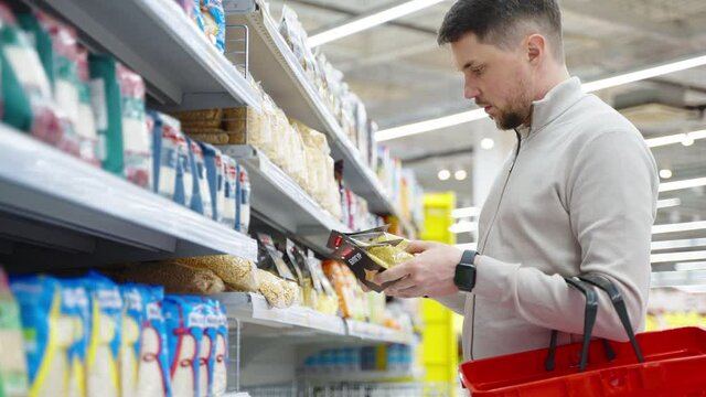 Man buying bulgur wheat in the supermarket