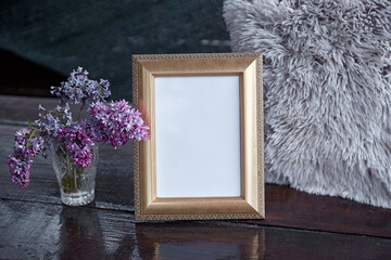Elegant mock up picture frame with lilac flowers. Minimalistic concept. Scandinavian interior.