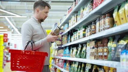 coffee lover is choosing instant coffee in supermarket, man is buying soluble coffee