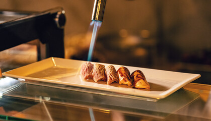 Chef cooking salmon sushi