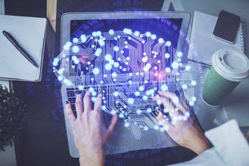 Double exposure of woman hands working on computer and brain hologram drawing. Ai concept.