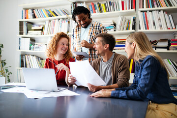 Successful group of designers, business people at work in office
