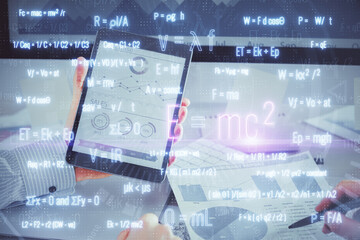 Double exposure of man's hands holding and using a phone and formulas drawing. Education concept.