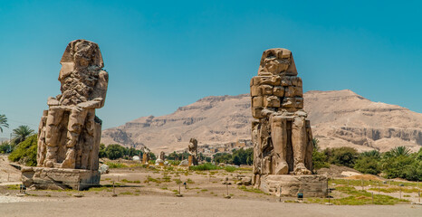 Panorama view of the Colossi of Memnon statues at the entrance of Luxor, Egypt