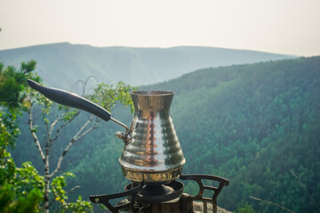 Brewing fresh coffee in a Turk in nature