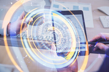 Double exposure of man's hands holding and using a digital device and tech theme hologram drawing. Technology concept.