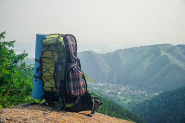 Tourist backpack on the top of the mountain