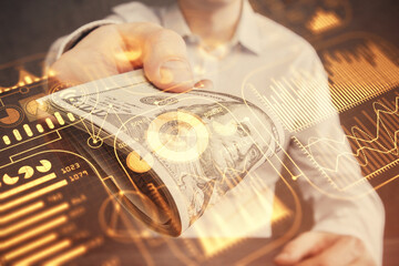 Multi exposure of Tech drawing hologram and USA dollars bills and man hands. Technology concept.