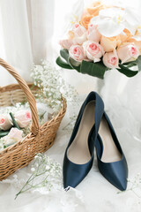 wedding shoes and bouquet in a basket
