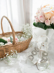 wedding shoes and bouquet in a basket
