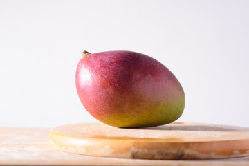 Fresh palmer mango fruit on wooden with white background, Tropical fruit - obrazy, fototapety, plakaty