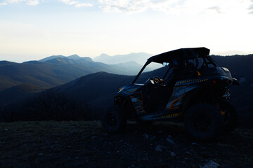 Fototapeta premium Buggy machine parked in mountains at sunset