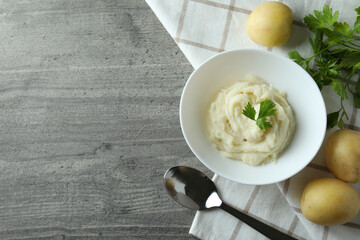 Concept of tasty eating with mashed potatoes on gray textured table