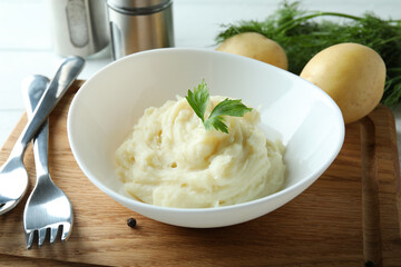 Concept of tasty eating with mashed potatoes on white wooden table