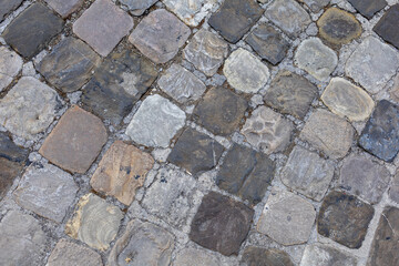 lose up shot of an historical, heritage paved road in a medieval burg in Italy called Sant'Arcangelo di Romagna. Road made with small square shiny stones called SANPIETRINI.
