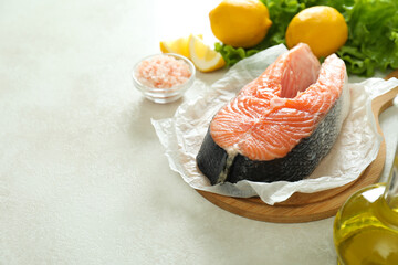 Concept of cooking salmon on white textured background