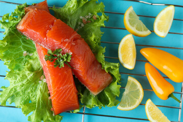 Concept of cooking salmon on blue background