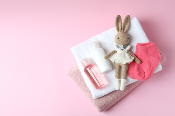 Different baby hygiene accessories on pink background
