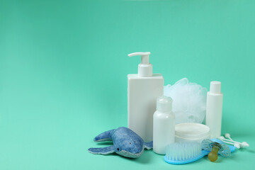 Different baby hygiene accessories on mint background