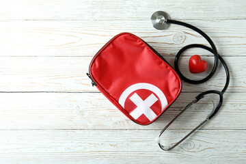 First aid medical kit on white wooden table