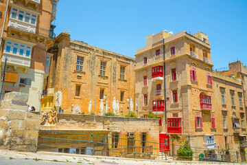 Fototapeta na wymiar Valletta, Malta. Old walls and buildings on Malta - travel photography. Valletta cityscape, the capital of Malta. Traditional Maltese architecture. Old historical part of La Valetta.