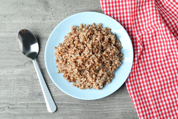 Concept of tasty eating with buckwheat on gray table