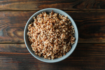 Bowl of tasty buckwheat on wooden table