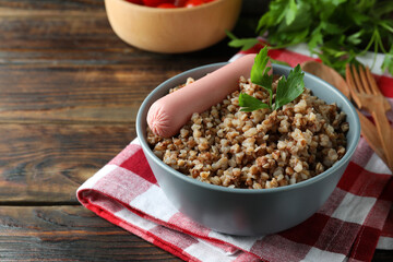 Concept of tasty eating with buckwheat on wooden table