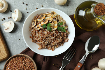 Concept of tasty eating with buckwheat on gray textured table
