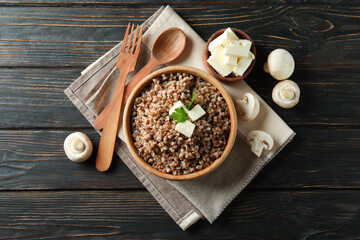 Concept of tasty eating with buckwheat on wooden table